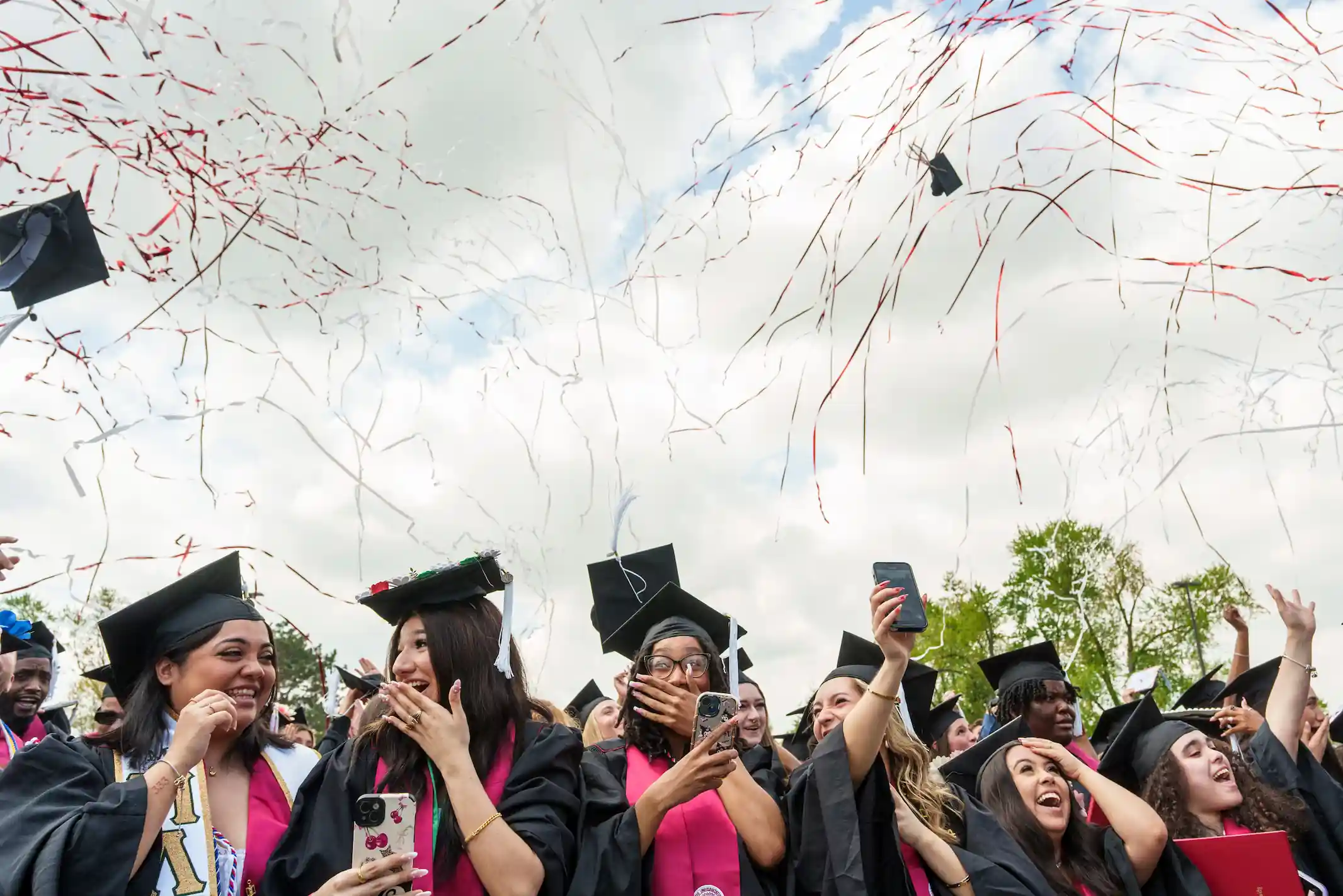 A group of students celebrate at graduation.