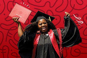 IUN student at commencement holding their diploma