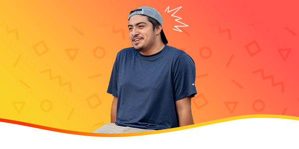 Student in front of a yellow-orange gradient background