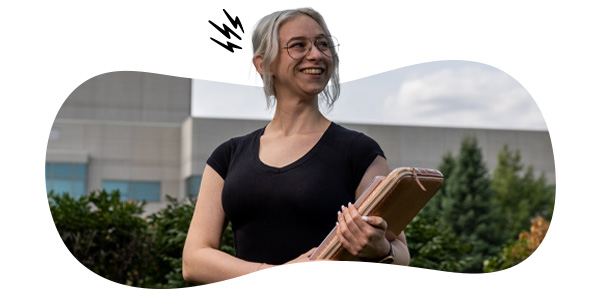 A student looking towards the right holding school supplies with an illustrative burst on the left side of her head