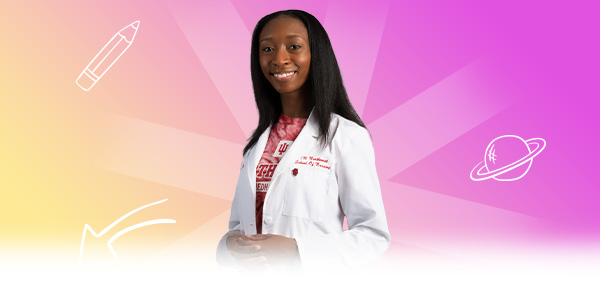 A student wearing a white coat with academic icons around her