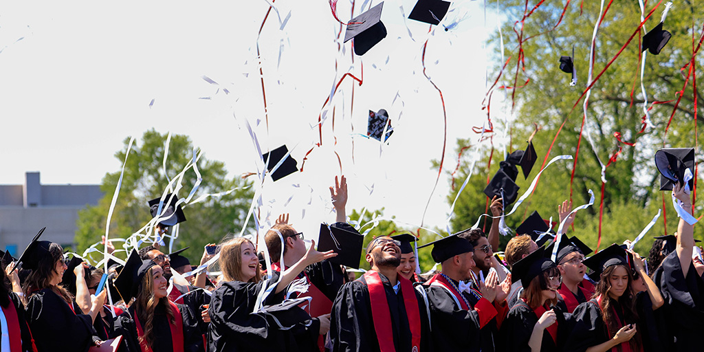 IU student during commencement, wearing a cap and gown